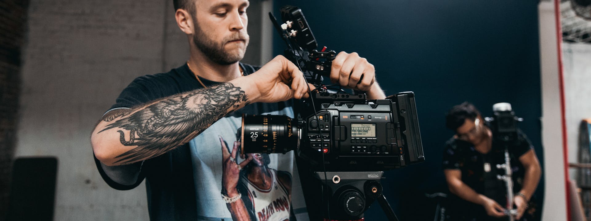Videographer adjusting cinema camera